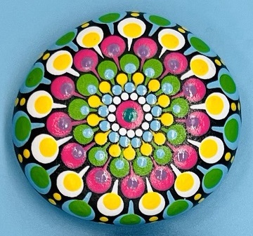 Pebble painted with colourful dots in mandala design.