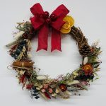 Dried Christmas wreath, made in wreath making workshop, hanging on door.