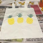 Lino printed tote bag with yellow and green pineapple design printed in lino printing workshop