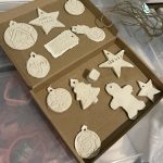 Finished white clay Christmas decorations in cardboard box. Made in Christmas designs, embossed with Christmas shapes and patterns.