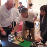 Team moving Lego for stop motion in Lego animation team activity.