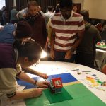 Team moving Lego for stop motion in Lego animation team activity.