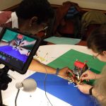 iPad on tripod filming Lego scene in Lego Animation team activity.