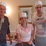 Team in chef hats taking part in corporate bake off team activity.